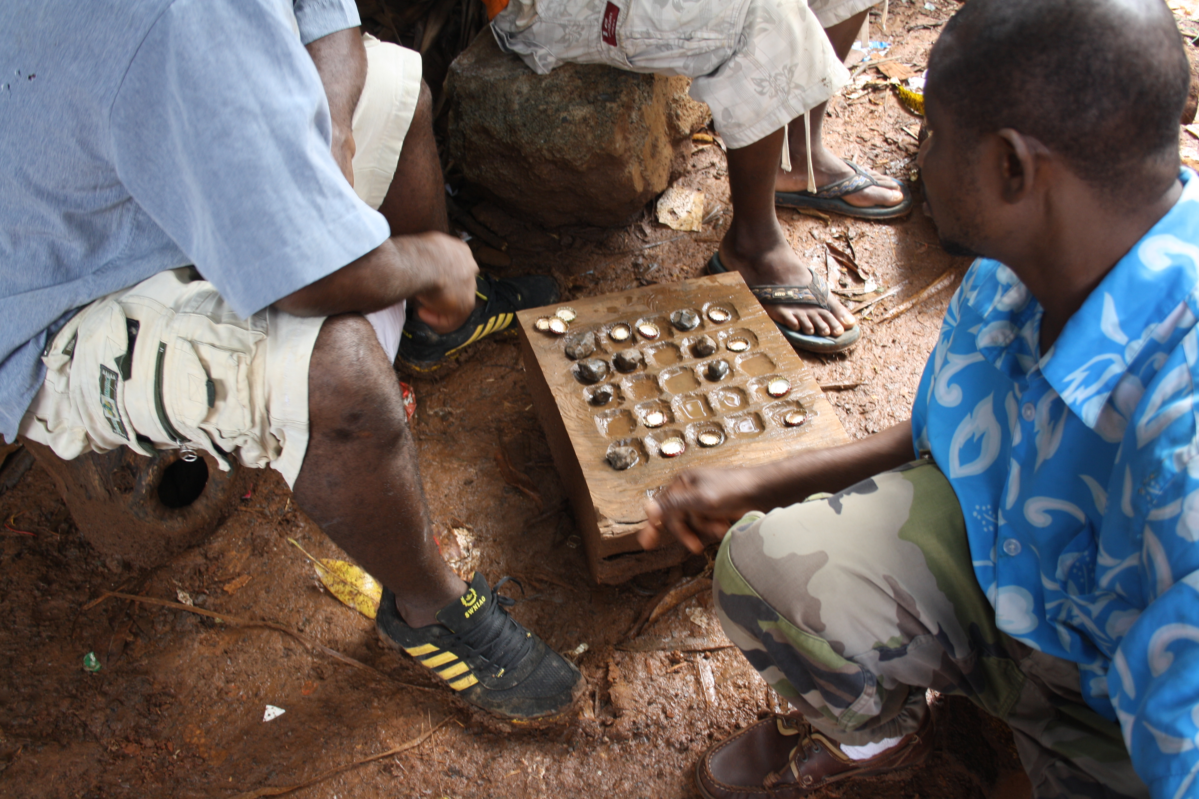 Mayotte, hommes jouant au mraha dans leur bidonville